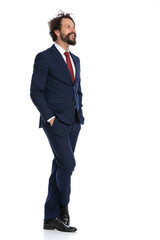 side view of a happy businessman crossing his legs