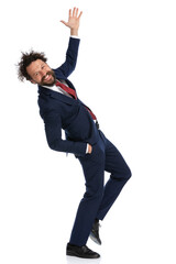 handsome businessman raising one hand and one leg