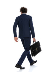businessman walking one way and looking the other way