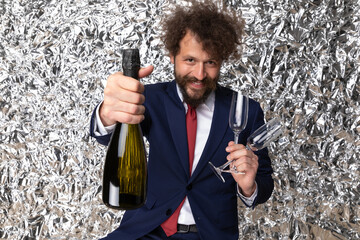 elegant bearded man with moustache showing and recommending champagne bottle