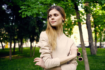 beautiful woman sunglasses and a hat in the park green grass model