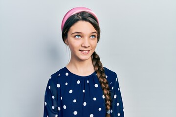 Young brunette girl wearing elegant look looking away to side with smile on face, natural expression. laughing confident.