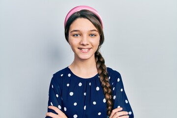 Young brunette girl wearing elegant look happy face smiling with crossed arms looking at the camera. positive person.