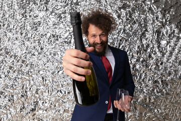 enthusiastic elegant man recommending champagne bottle