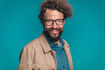 enthusiastic unshaved guy with glasses smiling and posing