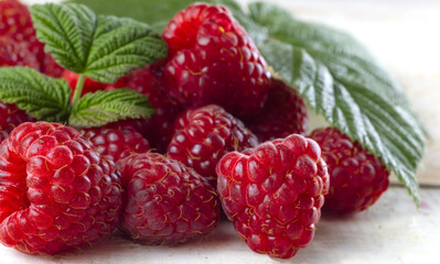 image of raspberries with leaves on a white background
