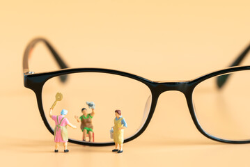 Miniature people Housewife Maid or Worker standing and cleaning dirty reading glasses using as Hospitality Hotel cleaning service business or health care healthy and wellness life style safety concept