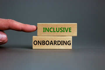 Inclusive onboarding symbol. Wooden blocks with words Inclusive onboarding on beautiful grey...