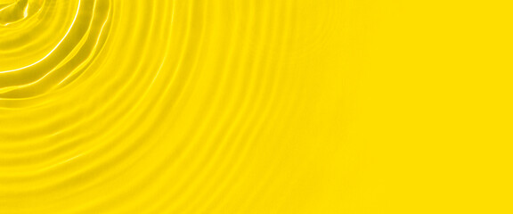 Abstract yellow water over sunlight. Top view, flat lay. Banner