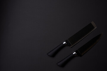 Black friday concept. Set of sharp kitchen knifes. Black knifes on dark background