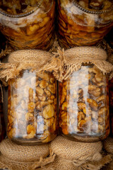 Homemade glass jars with walnuts and honey