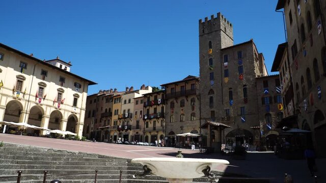 Panoramic view of Piazza Grande square in Arezzo, Tuscany, Italy, Incidental People passing by