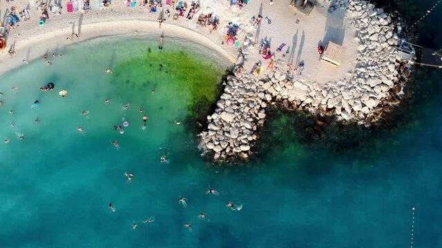 Drone view of the Croatian city of Split in the resort region of Dalmatia. Shot from a drone of a beach in Split. Croatia beach. People sunbathe on the beach view from a drone. Split architecture
