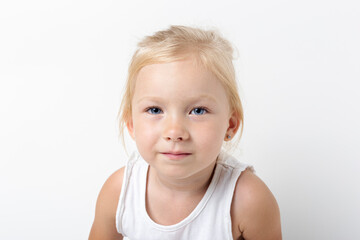 Beautiful pensive blonde girl on a light background in the studio