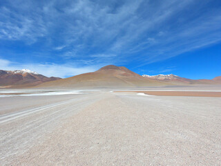 A road between two salt lakes in the stone desert of Bolivia near the city of Uyuni. Eduardo Avaroa...