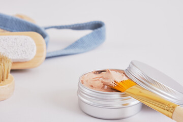 makeup brush and cosmetic red clay in aluminum jar, natural cosmetics and zero waste lifestyle