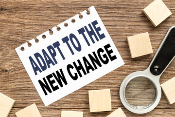 Adapt To The New Change, white sheet of paper and wood planks on wood background