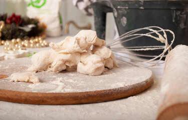 TEsto in flour on a board with space for text. Bake New Year's cookies for the new year and Christmas in the kitchen