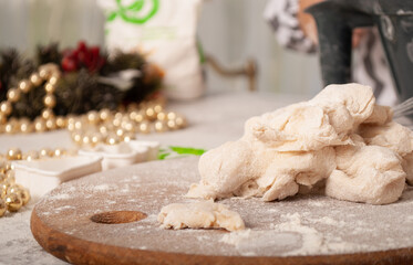TEsto in flour on a board with space for text. Bake New Year's cookies for the new year and Christmas in the kitchen