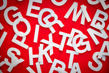 Mixed letters pile top view photo. Red background