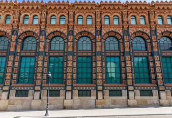 Curved windows with green reflections in this classic facade of the city of Barcelona