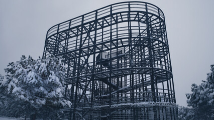 An Unfinished Iron Tower Covered With Snow