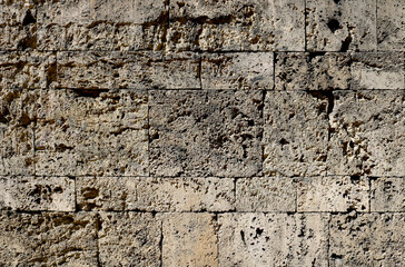 Damaged granite stone surface from a wall of a fortress with big bricks, textured with moisture - dirty pattern with for a medieval background	