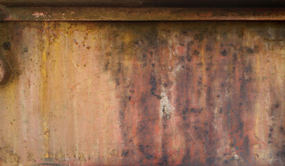 rusty and weathered metal surface with orange, red and black tones, framed up - worn irregular industrial background with scratches	
