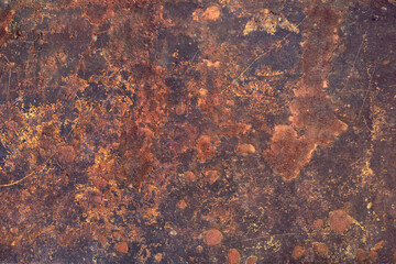 extremely rusty metal surface of a plank, with abstract shappes and forms in orange tones over a dark background - closeup worn texture