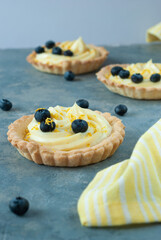 Tart with cream and blueberry and lemon shavings