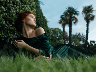 Naklejka na ściany i meble pretty woman lying on the lawn decoration garden fantasy