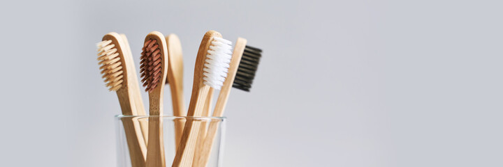 Set of ecology toothbrush on grey background. Different color glass. Diversity concept. Sustainable...