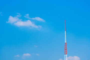 red and white large tower and the sky and clouds background
