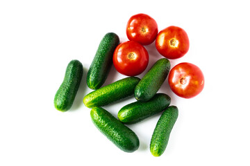 plan view of green fresh cucumbers and red tomatoes isolated on white background
