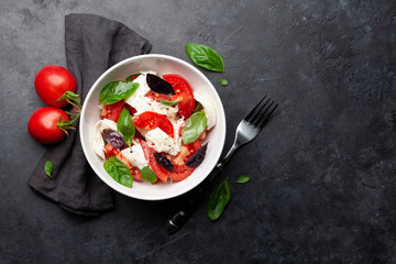 Caprese salad with fresh tomatoes, garden basil and mozzarella cheese