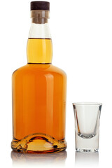 A bottle of whiskey on and a shot glass