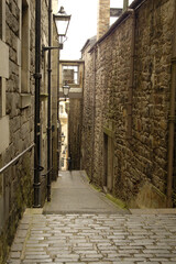 old historic narrow close and lamps in Edinburgh