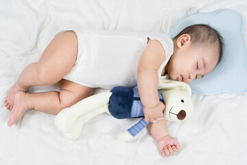 Selective focus portrait of a sleeping Charming baby Cute newborn sleeps with a toy teddy bear on comfortable bed