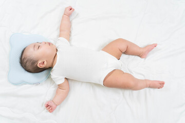 Sleeping baby, selective focus portrait of charming newborn  on comfortable bed