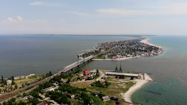 Drone view of Zatoka in Odessa. The bridge stands on the border between the Black Sea and the Belgorod-Dnestrovsky estuary. A bridge between two torn parts of the Budak Spit. Resort town