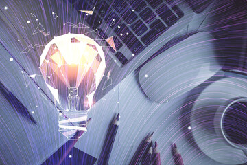 Bulb drawing over computer on the desktop background. Top view. Double exposure. Idea concept.