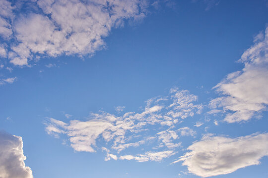 clouds in a blue sunny sky © vadiar