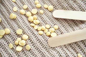 Remove hair equipment. Spa epilation service flatlay. Wax granules. Depilatory pearl drops. Hard texture material. Yellow pills. Trend woman beauty center. Wood sticks