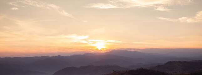 Landscape view of mountain at sunrise. Environmental background. Cloudy sky for web banner.