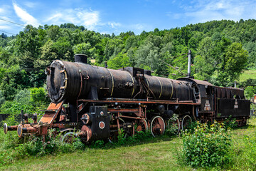  The old steam locomotive is parked in a depot