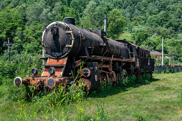  The old steam locomotive is parked in a depot