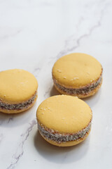 Traditional Argentinian alfajores with dulce de leche on marble table. Argentine gastronomy concept.