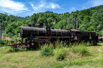  The old steam locomotive is parked in a depot 