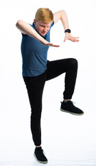 portrait of a red-haired guy in a blue t-shirt and jeans on a white isolated background. teenager...