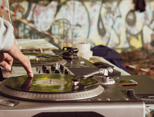 DJ playing music at a hip hop party. analog turntable, Dj uses turntable and mixer for scratching.